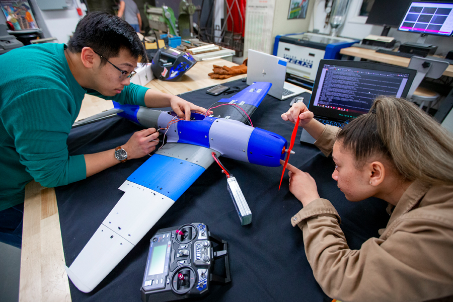 Two students work on a model aircraft in the Materials Lab in the College of Engineering and Computing Sciences. 