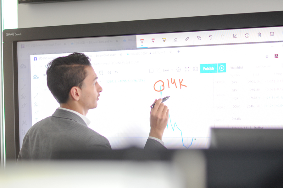 A student writes on a white board.