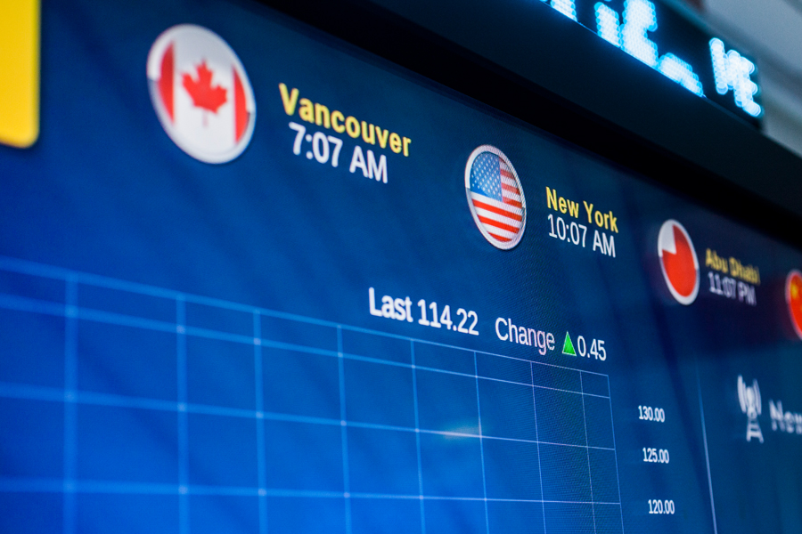 A screen highlights global time zones and stock market changes on New York Tech's Simulated Trading Floor.