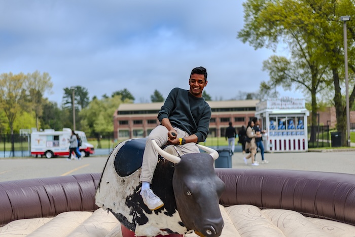 Student riding mechanical bull.