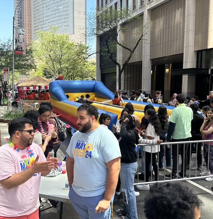 Line of students around a bouncy obstacle course