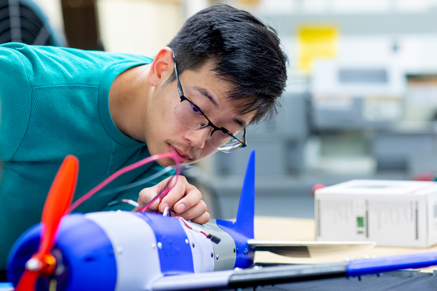 For the aerospace concentration, a Mechanical Engineering, B.S. student at New York Tech uses a model airplane to learn about motion and mechanical properties.