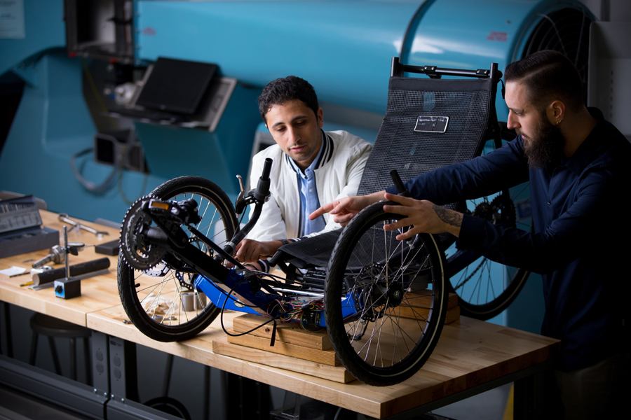 A professor and student working on a Tricycle. 