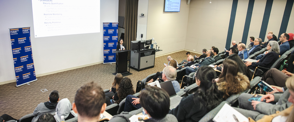 Attendees listening to a speaker at a podium