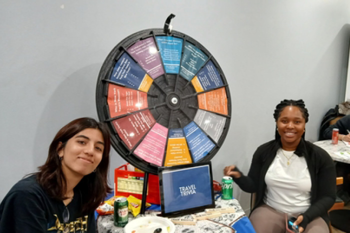 Students next to a spinning wheel