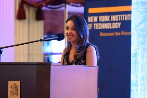 Ghita Akkar at a podium