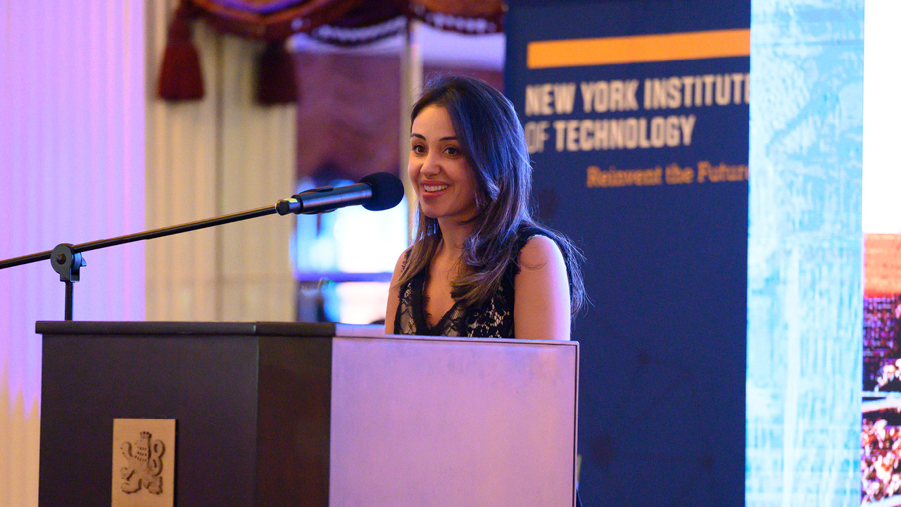 Ghita Akkar at a podium