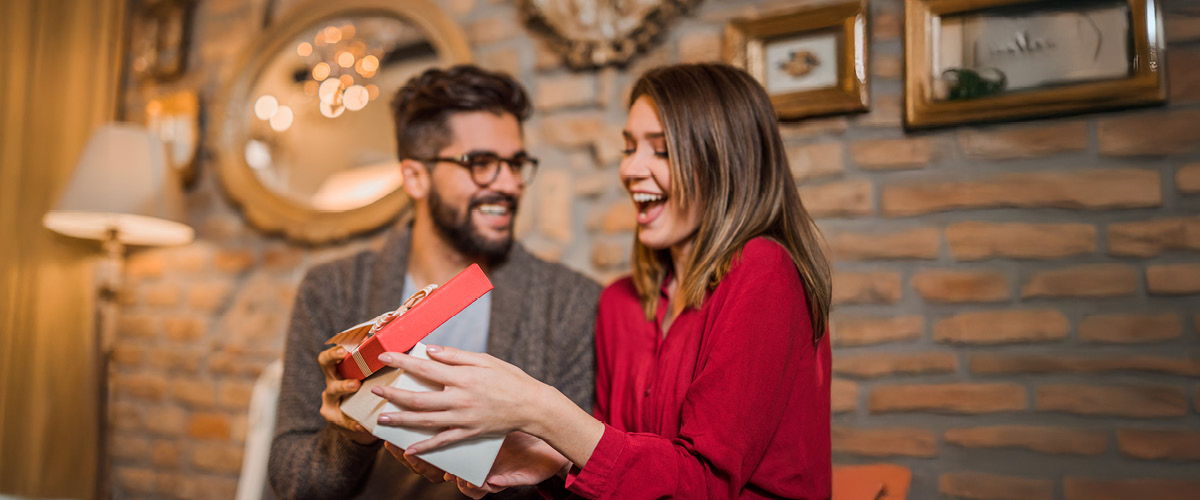 Man and woman exchanging gifts