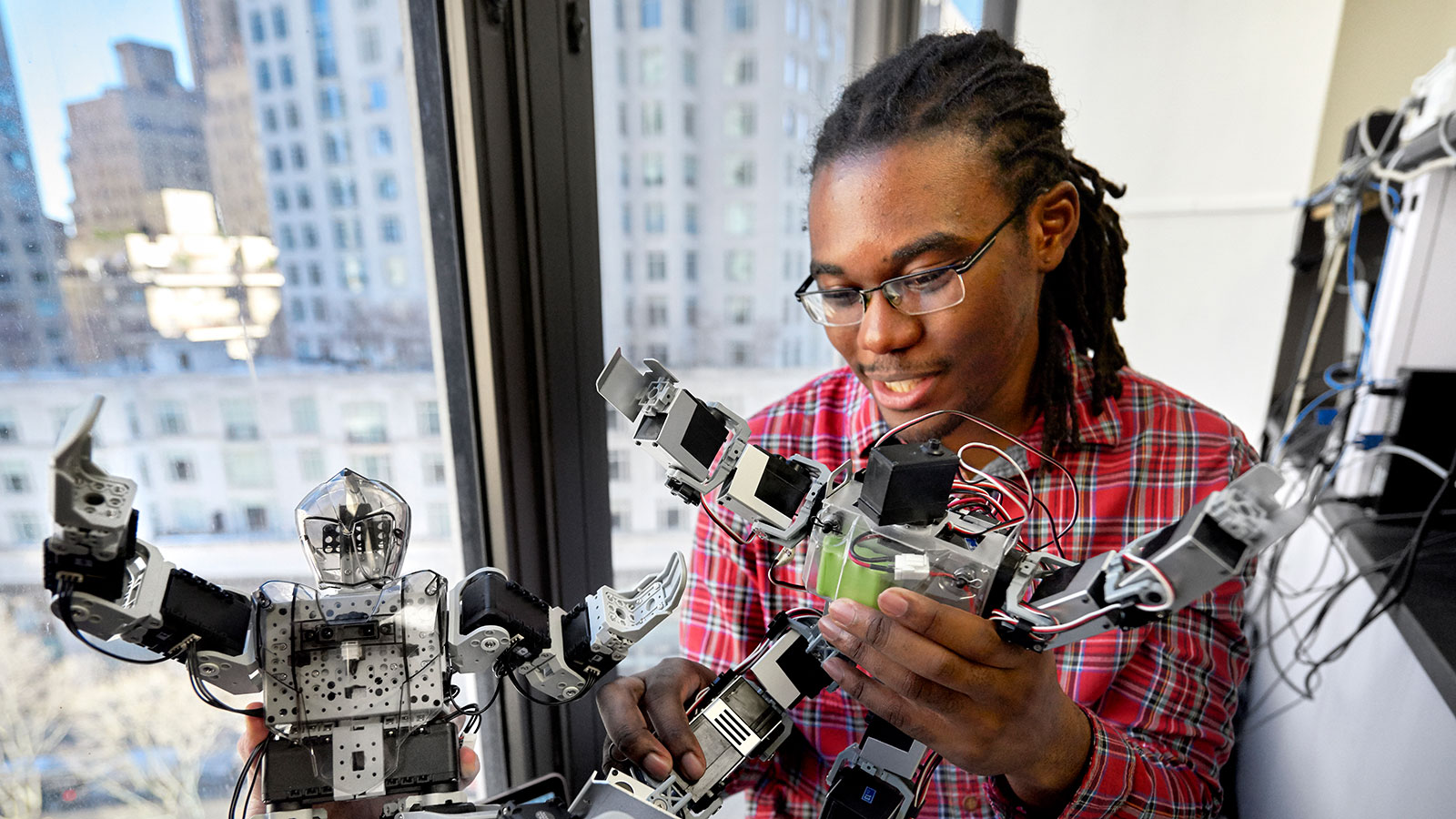 A student programs a robot.