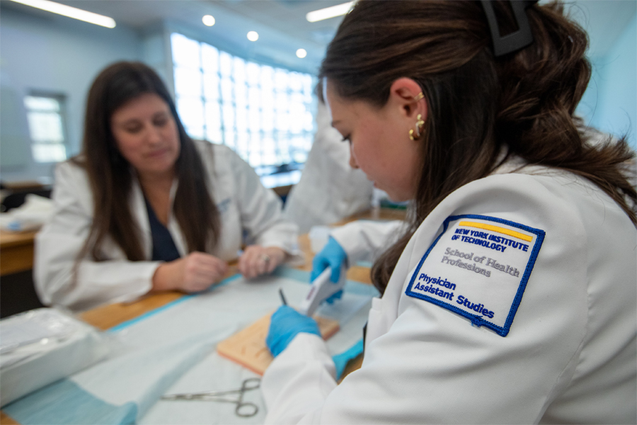 A physician assistant student practicing sutures.