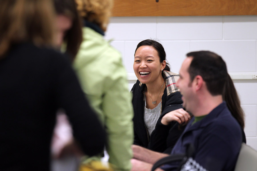 Smiling New York Tech students talk among themselves in a class for one of the Department of Psychology and Counseling's graduate programs.