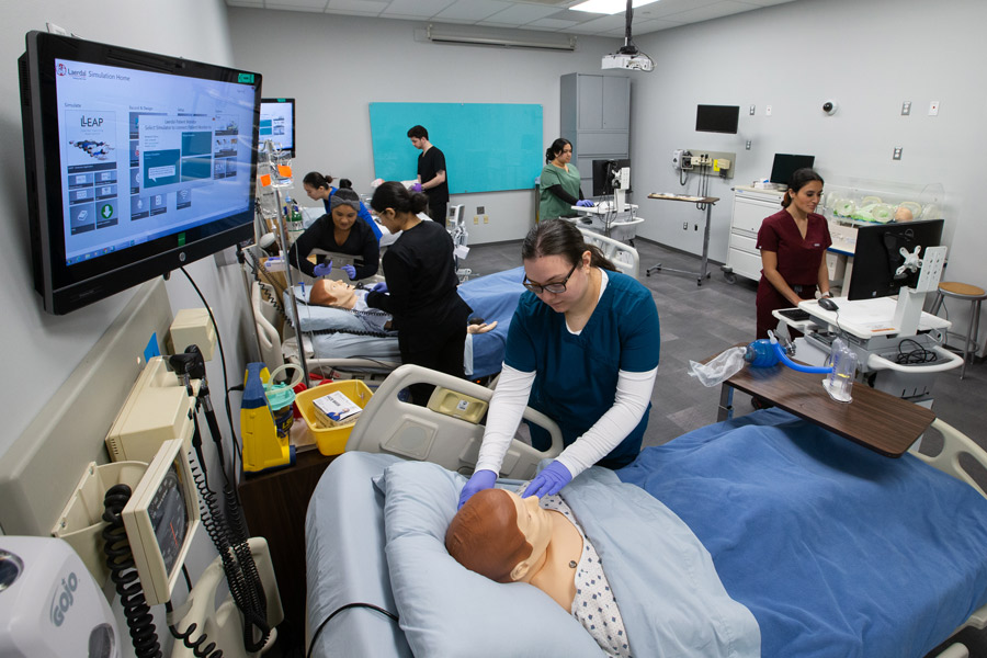 Students in a healthcare facility practicing attending patients.