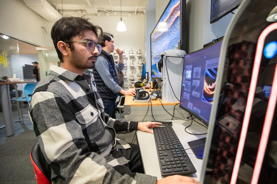 student working on a computer in the h.i.v.e.