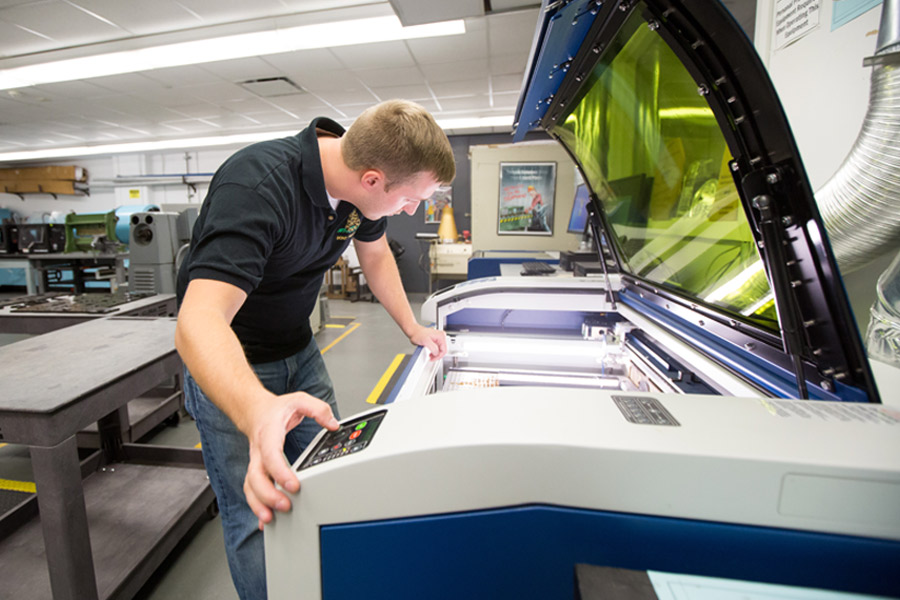 A person working in a lab with a prototyping machine.